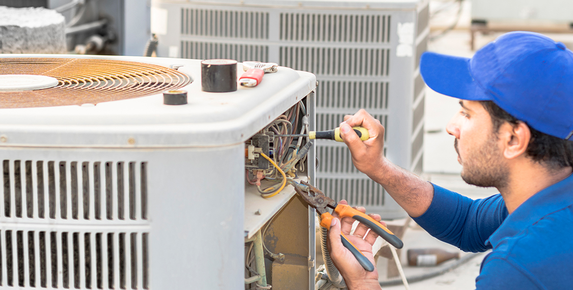 Technician repairing an HVAC unit